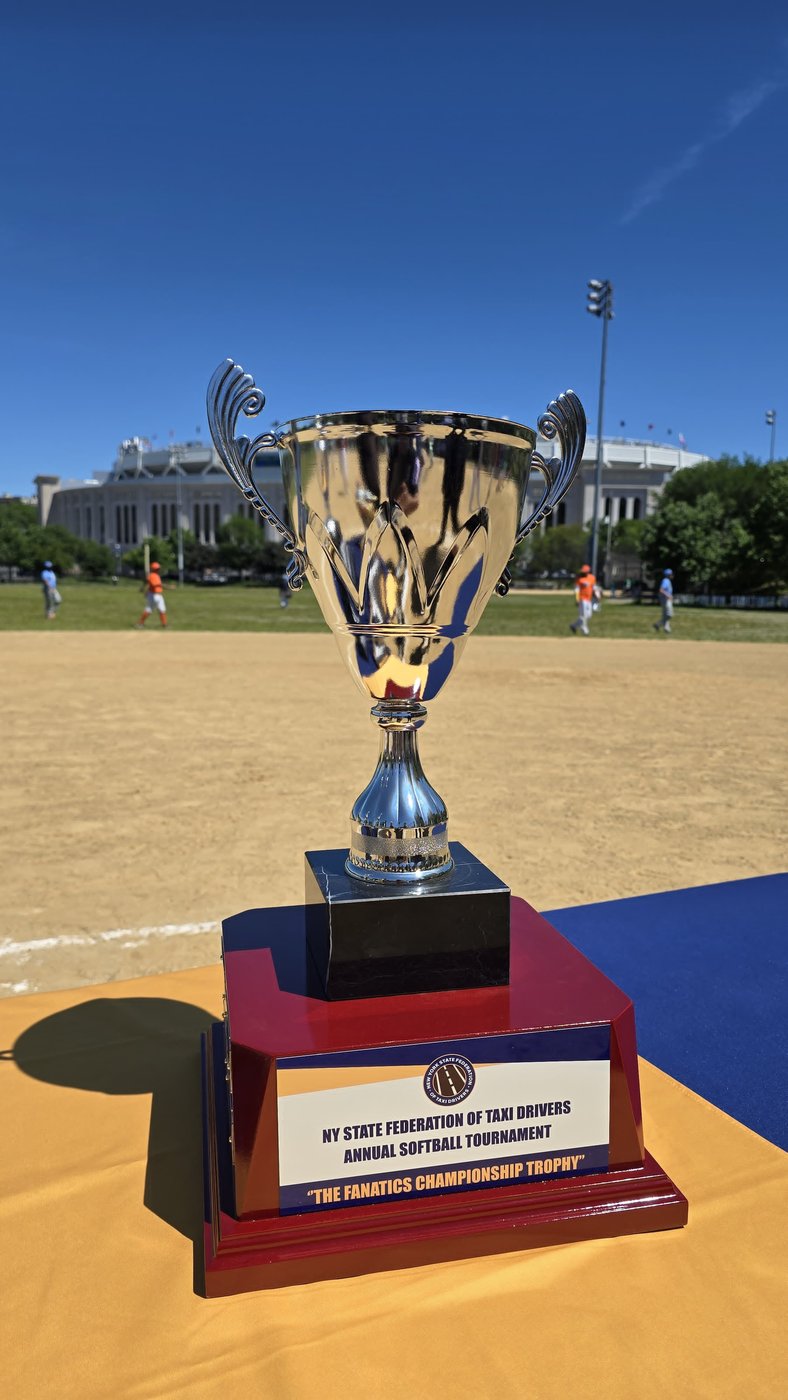 The Fanatics Championship Trophy with Yankee Stadium behind it